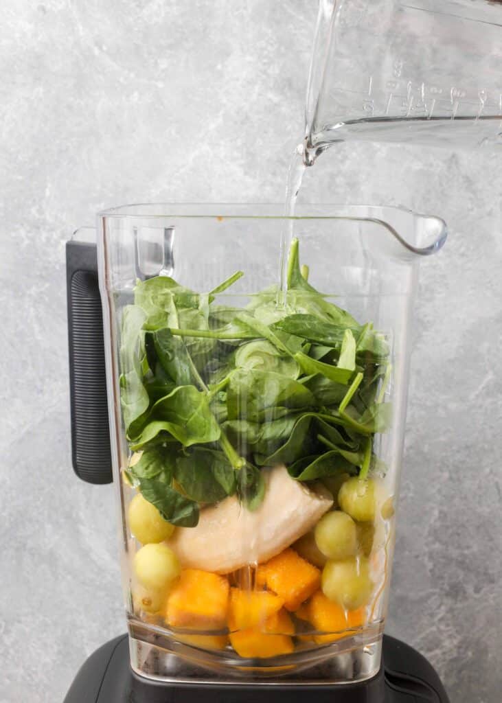 mango, grapes, banana, and spinach in blender for smoothie