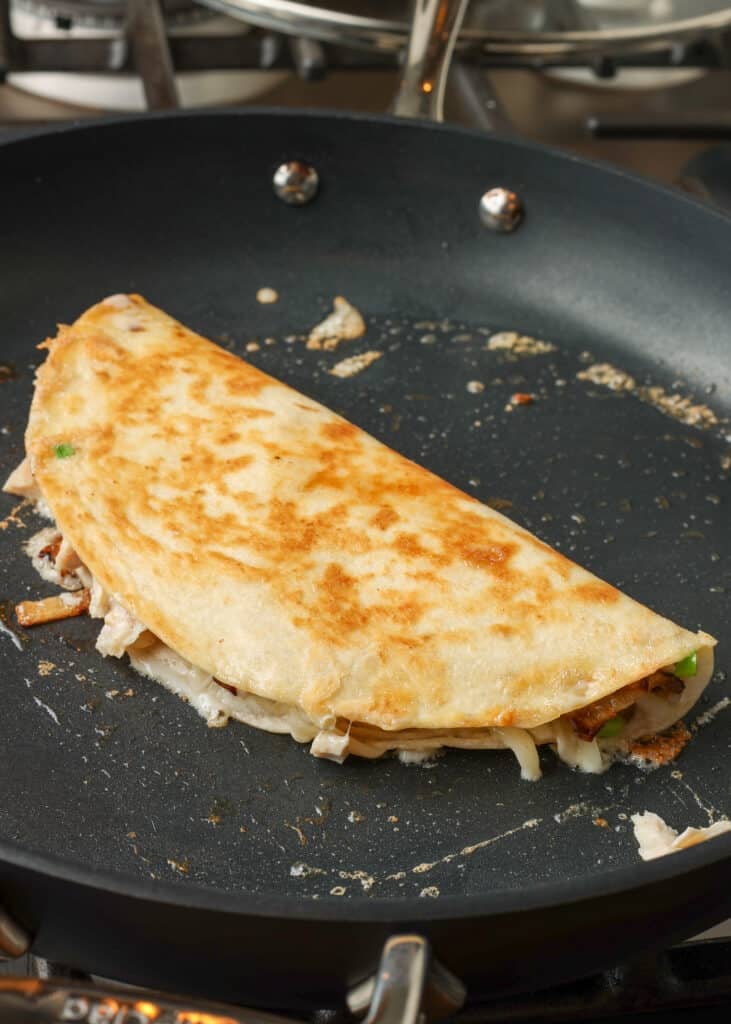 folded quesadilla in skillet - 6