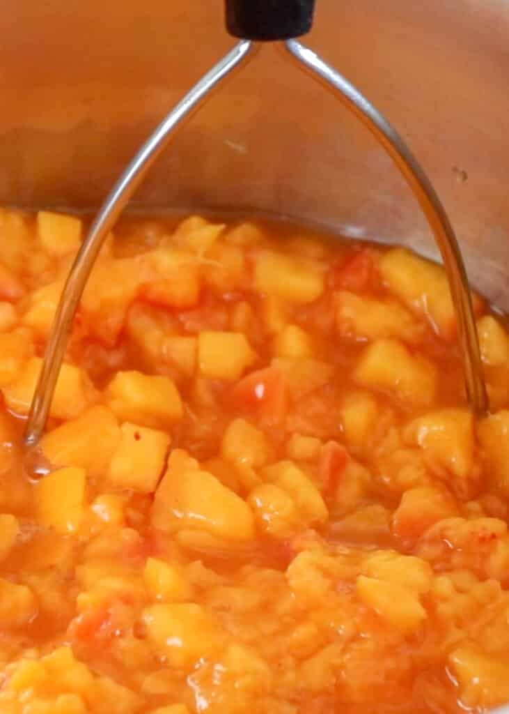 Simmering fresh peaches for jam making - get the recipe at barefeetinthekitchen.com