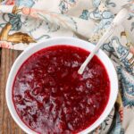 Homemade Cranberry Sauce on wooden table with floral napkin