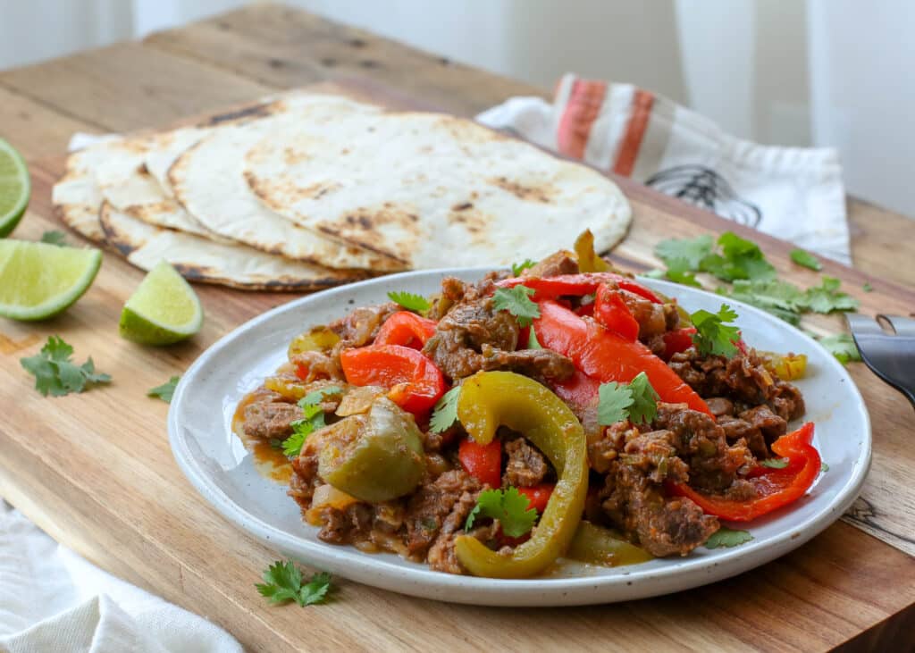 Steak Fajitas made in the crockpot are a family favorite! get the recipe at barefeetinthekitchen.com