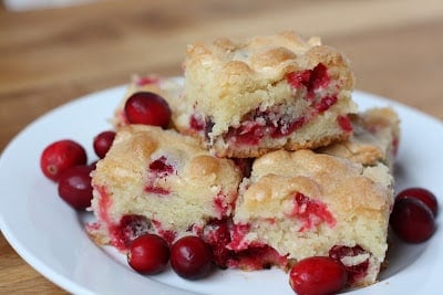 A piece of cake on a plate, with Cranberry and Tart