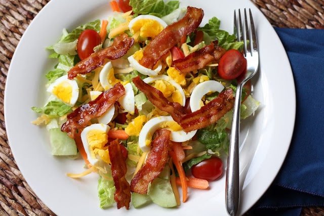 A plate of food on a table, with Salad and Egg