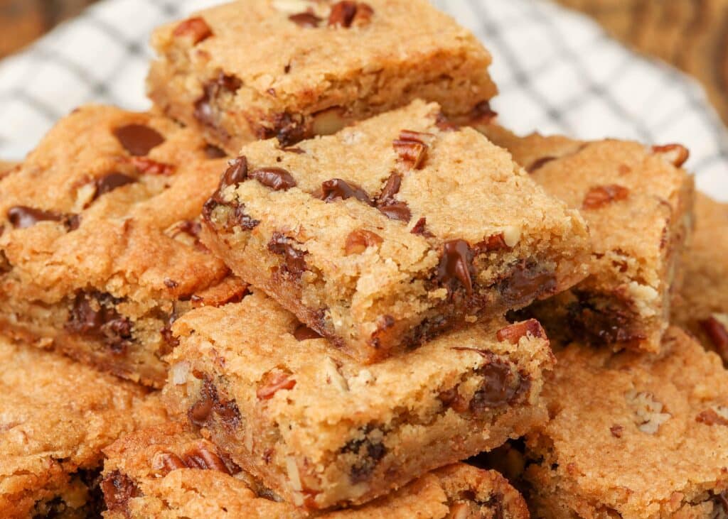 stack of blondies with pecans and chocolate chips
