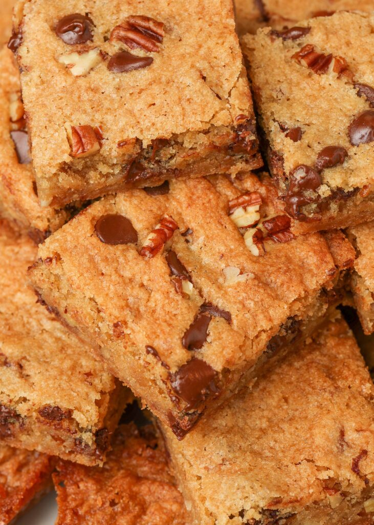 close up photo blondies with chocolate chips and nuts
