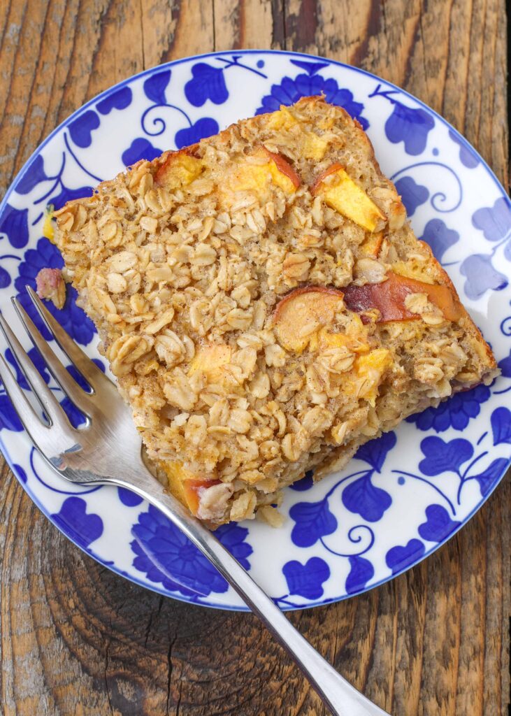 Baked Oatmeal with Peaches on pretty blue plate with fork