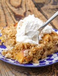 Baked Oatmeal with whipped cream on plate with fork