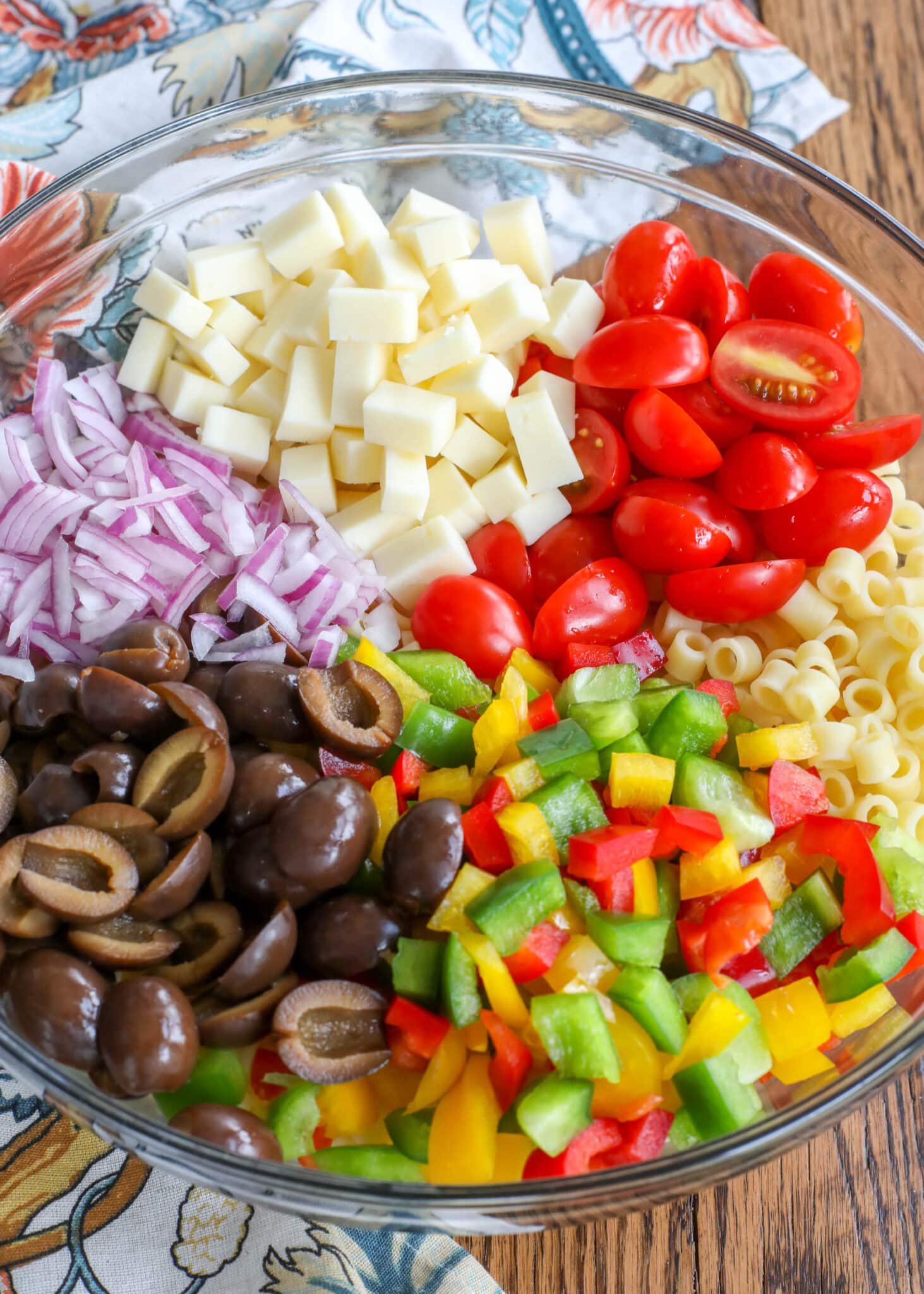 This Tangy Pasta Salad is filled with crunchy bell peppers and onions, tangy olives, and sweet tomatoes. Tossed in a light oil and vinegar dressing the recipe is great for summer parties.