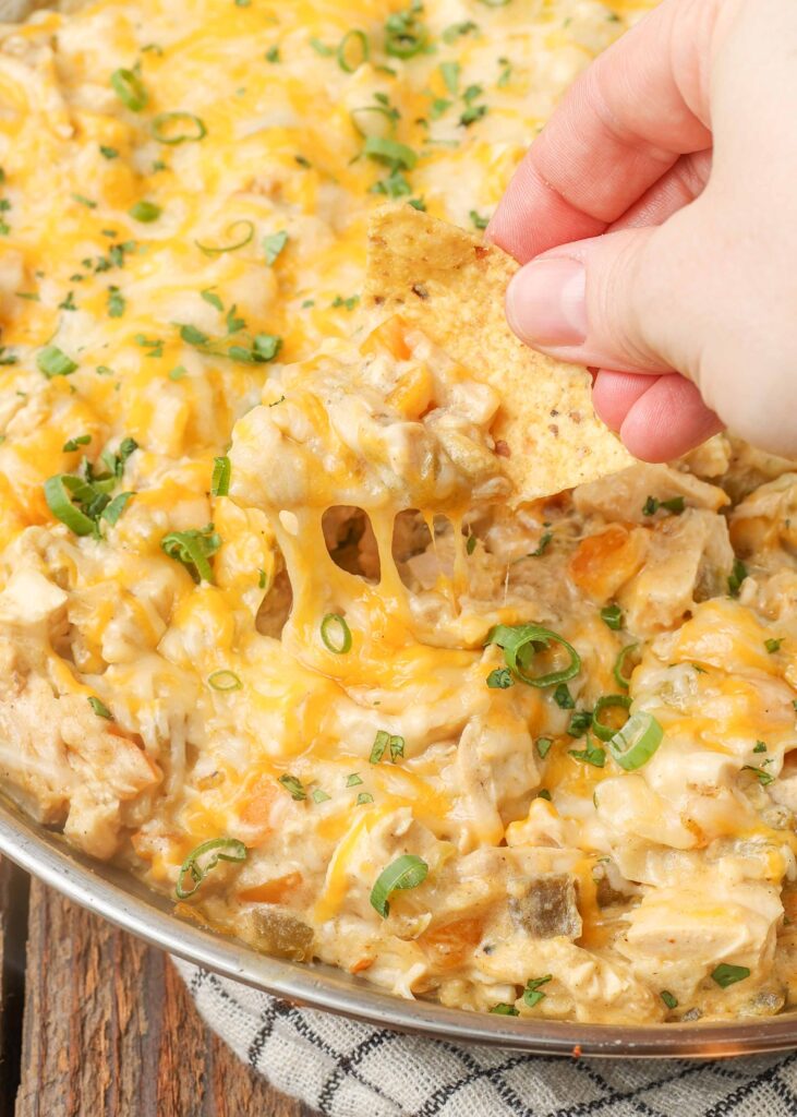 cheesy chicken dip scooped on tortilla chip