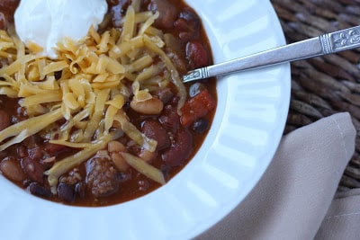 A bowl of food on a plate, with Sausage