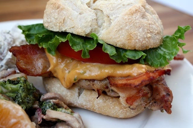 A close up of a sandwich on a plate, with Chicken and Bacon