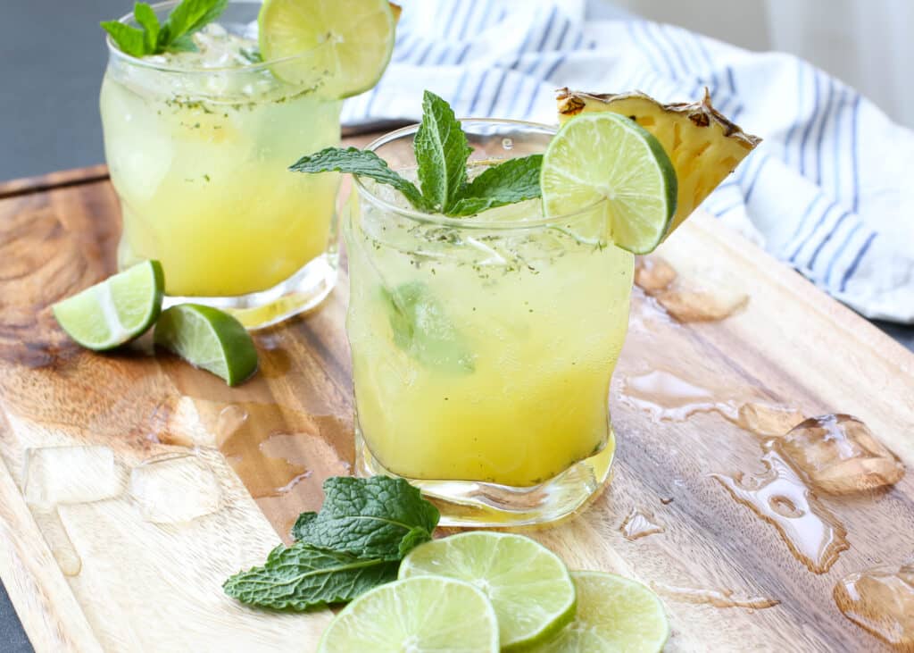 Pineapple Mojitos are a refreshing cocktail that everyone loves! get the recipe at barefeetinthekitchen.com