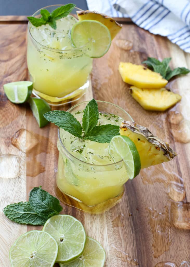 Pineapple Mojitos are a favorite for all ages - the "mocktail" is every bit as delicious as the cocktail! get the recipe at barefeetinthekitchen.com