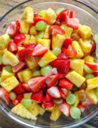 Pineapple, berries, and grapes are tossed in a honey lime dressing