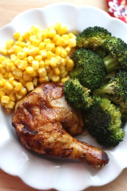 brown sugar chicken on white plate with broccoli and corn