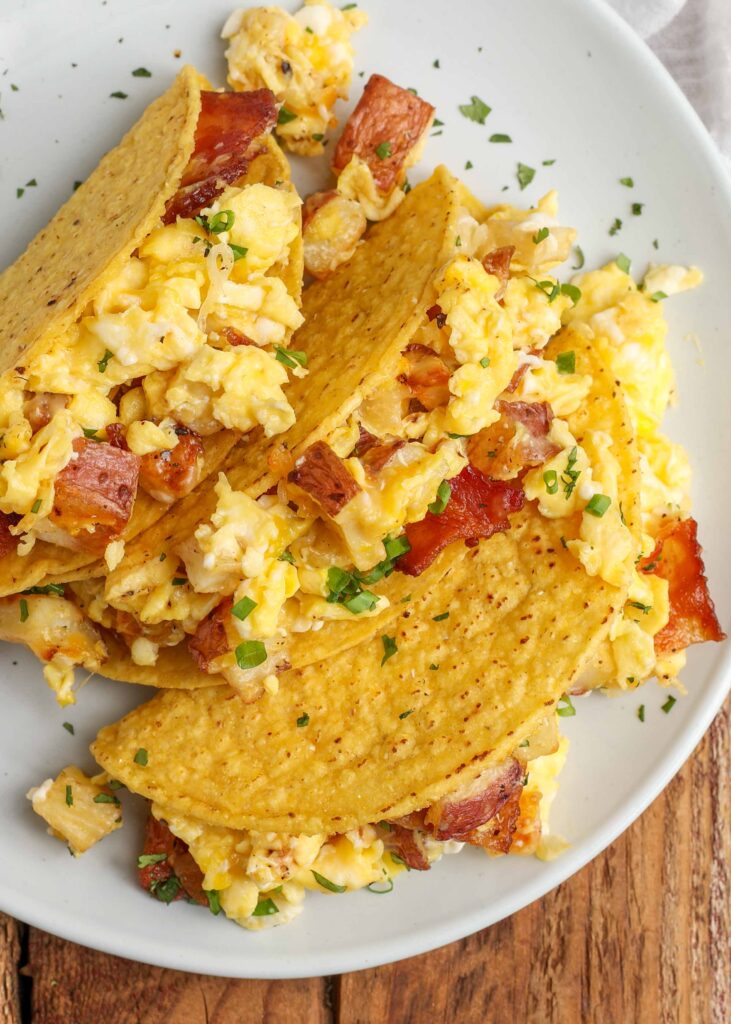 crisp taco shells filled with scrambled eggs, bacon, and potatoes