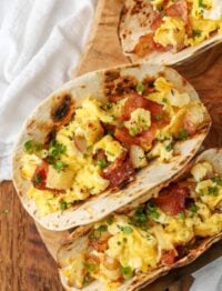 charred flour tortillas filled with bacon, eggs, and potatoes