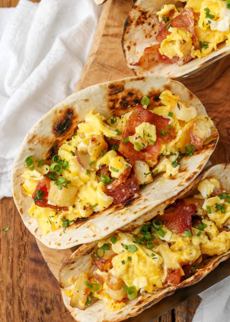 charred flour tortillas filled with bacon, eggs, and potatoes