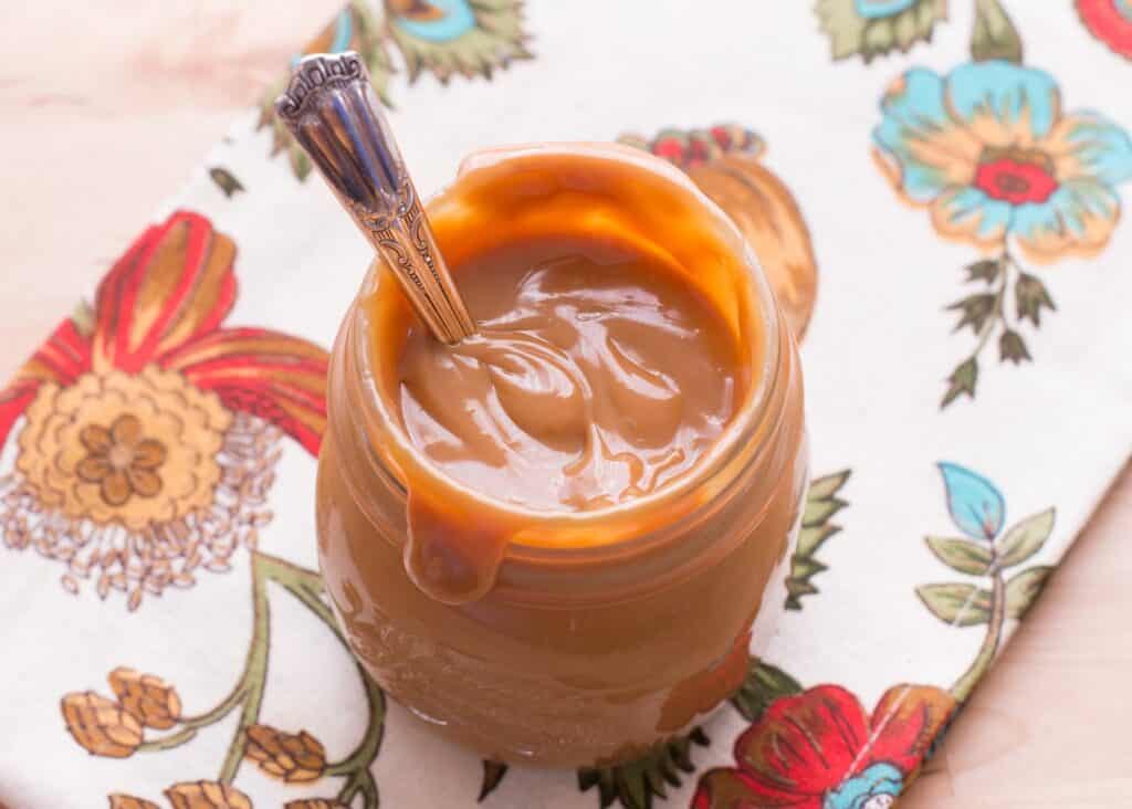 A cup of coffee on a table, with Caramel and Cream