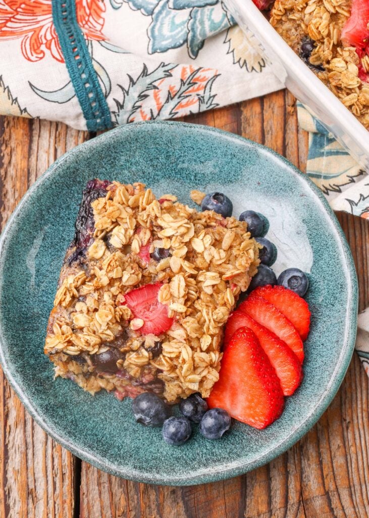 baked oatmeal with berries on blue plate