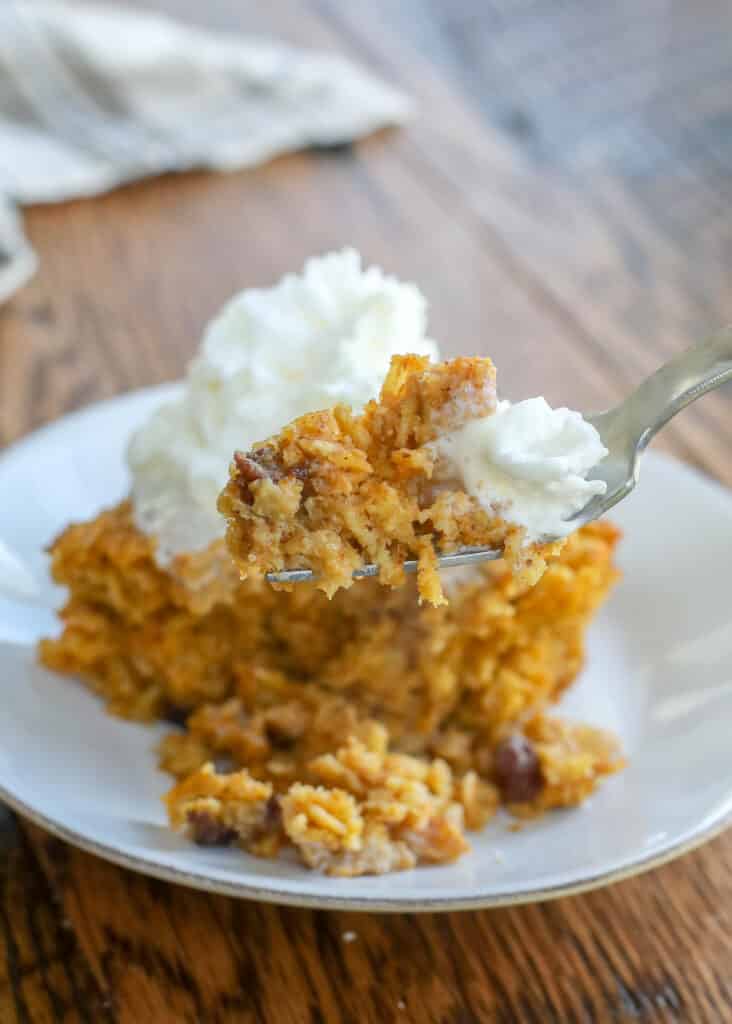 Warm pumpkin baked oatmeal topped with creamy cool whipped cream is a real breakfast treat! get the recipe at barefeetinthekitchen.com