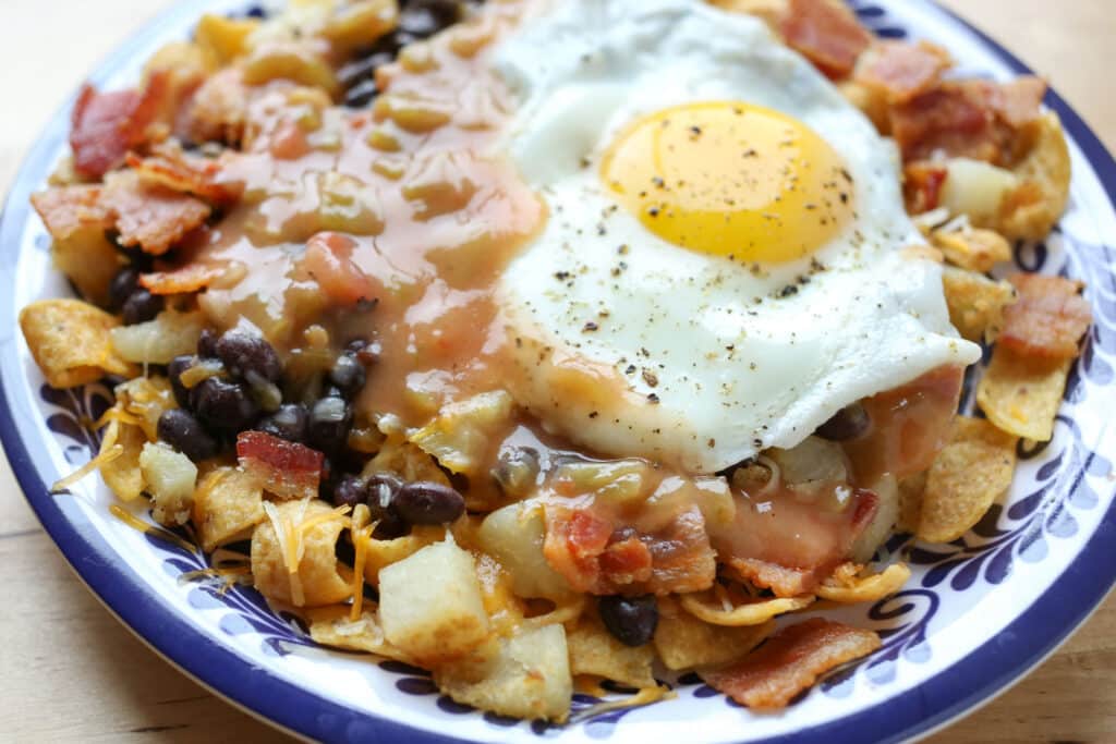 A plate of food, with Egg and Frito pie