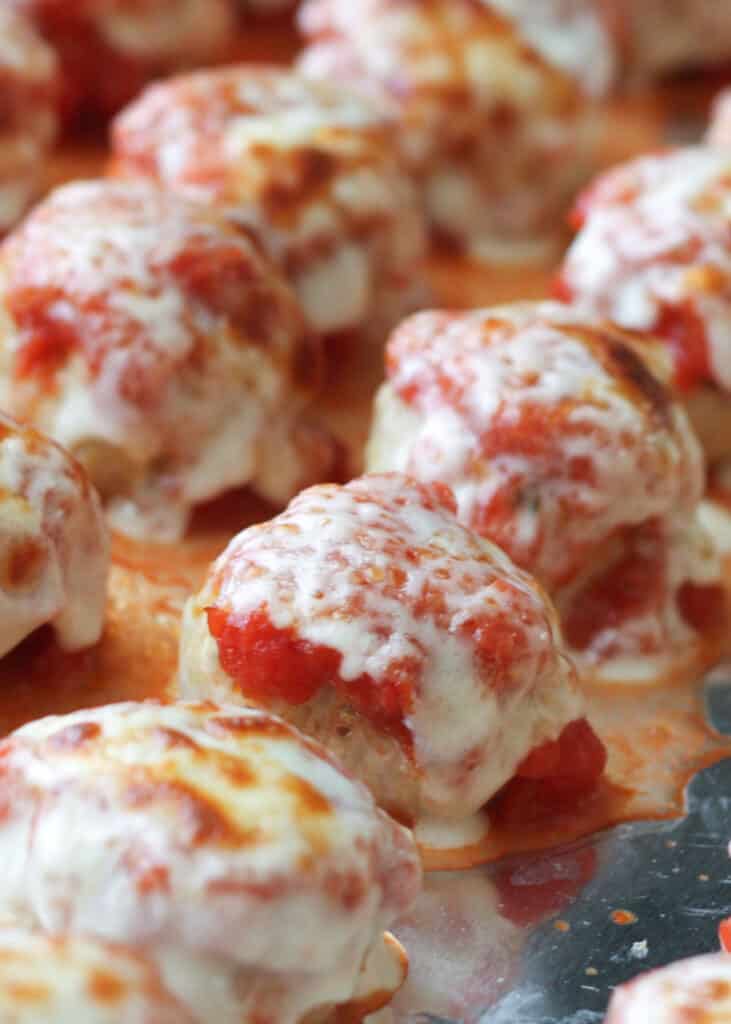 All the flavors of classic Chicken Parmesan are rolled into these bite size Chicken Parmesan Meatballs!