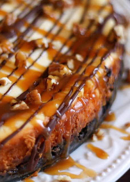 Turtle Cheesecake with caramel, chocolate, pecans, and an Oreo crust! - get the recipe at barefeetinthekitchen.com