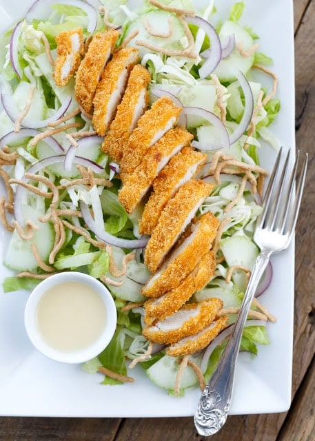 Inspired by Applebee's Asian Chicken Salad, this is a tangy, sweet salad filled with a simple blend of fresh vegetables, crispy hot chicken, crunchy noodles, and almonds. Get the recipe at barefeetinthekitchen.com
