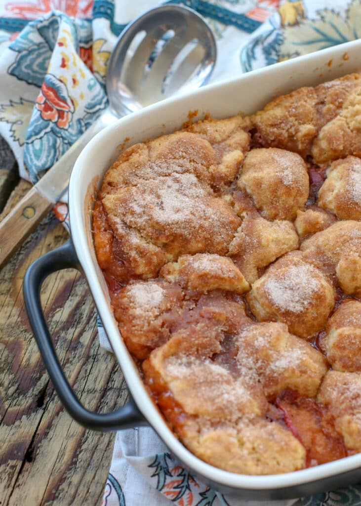 Southern Peach Cobbler with a flaky buttery crust and an abundance of juicy peaches! get the recipe at barefeetinthekitchen.com