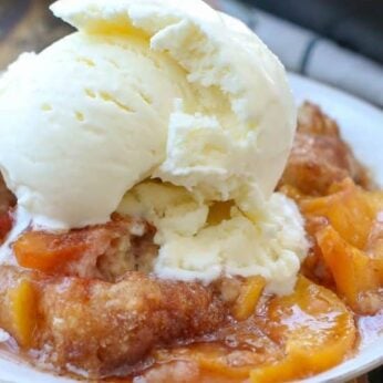 Peach Cobbler is the quintessential summer dessert with juicy peaches and a flaky buttery biscuit-like topping sprinkled generously with cinnamon and sugar!