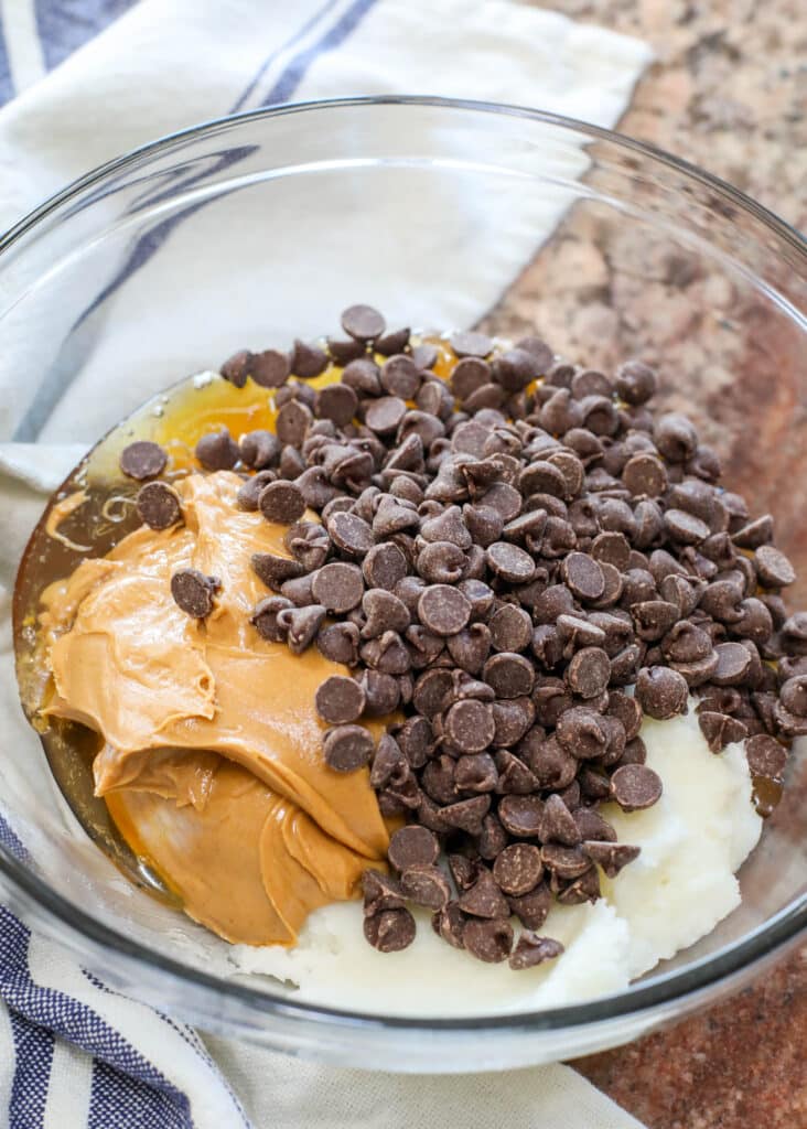 Peanut butter, coconut oil and chocolate chips in a bowl