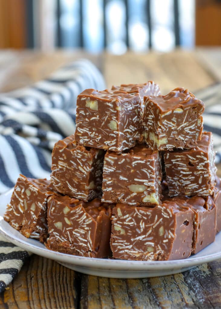 chocolate peanut butter bars with oatmeal and coconut stacked on plate