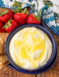 creamy fruit dip with lemon curd swirl in bowl with strawberries