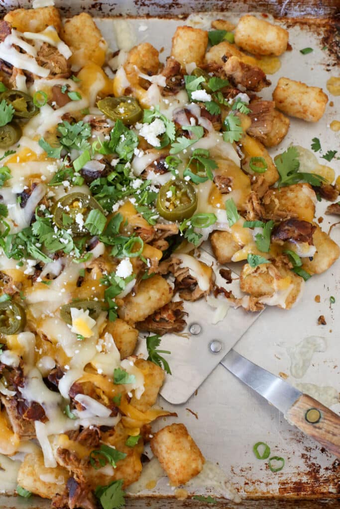 Pulled Pork Tater Tot Nachos disappear lightning fast! - get the recipe at barefeetinthekitchen.com