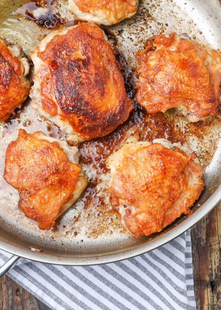 Pan Fried Chicken in skillet with striped towel