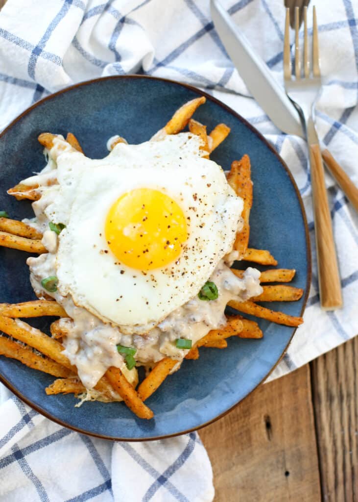 Crispy fries and melting cheese curds are topped with flavorful sausage gravy and an over-easy fried egg to make this Breakfast Poutine!