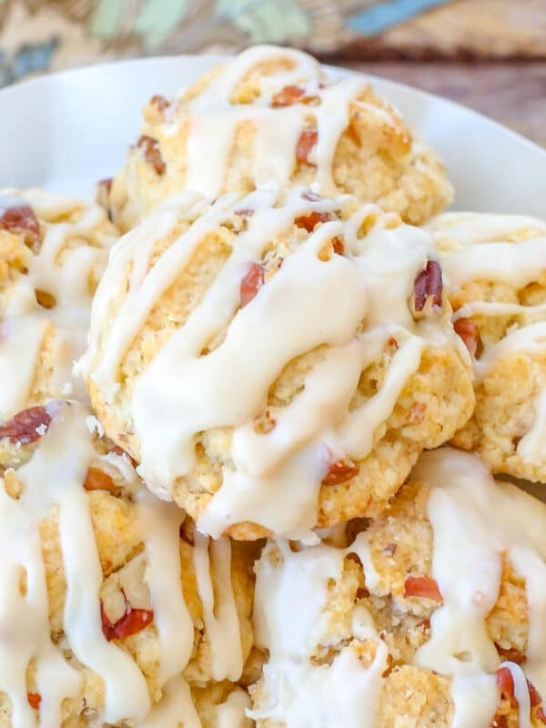 close up of maple cookies on white plate on wooden table