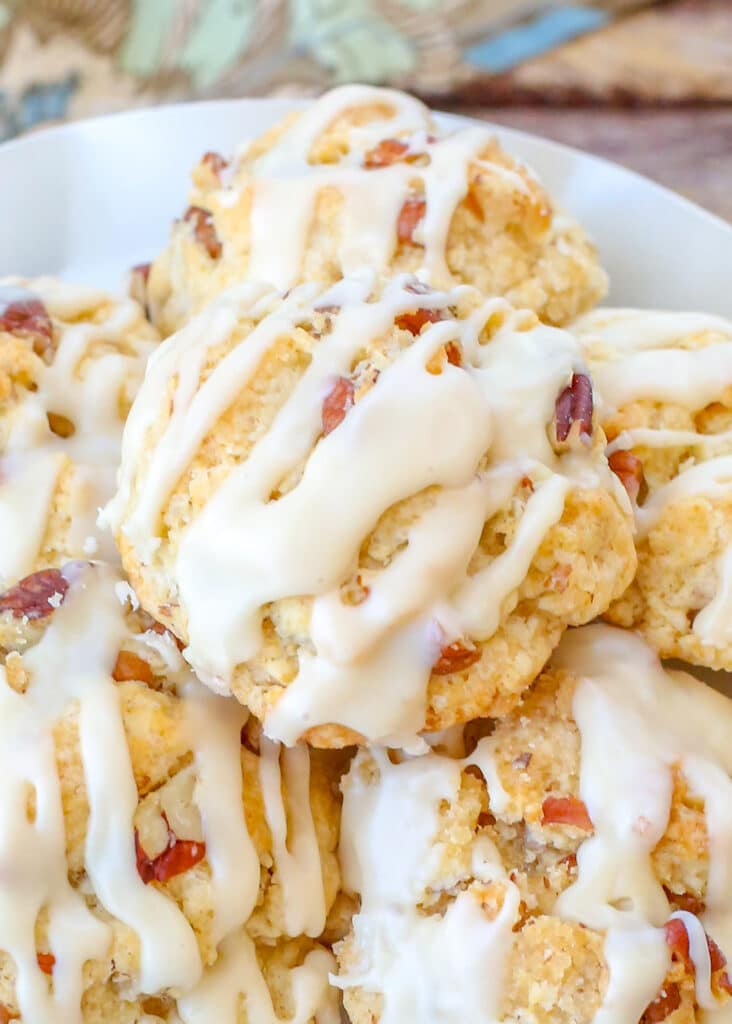 close up of maple cookies on white plate on wooden table - 6