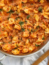 Sausage Tortellini Skillet with Creamy Tomato Sauce and Spinach is a kid and adult favorite. Get the recipe at barefeetinthekitchen.com