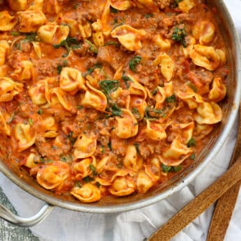 Sausage Tortellini Skillet with Creamy Tomato Sauce and Spinach is a kid and adult favorite. Get the recipe at barefeetinthekitchen.com