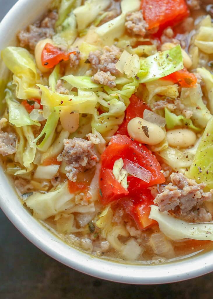 close up photo of cabbage soup with sausage