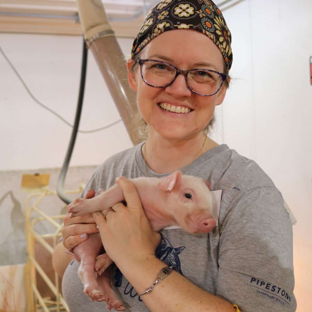 Holding piglet at Pipestone 