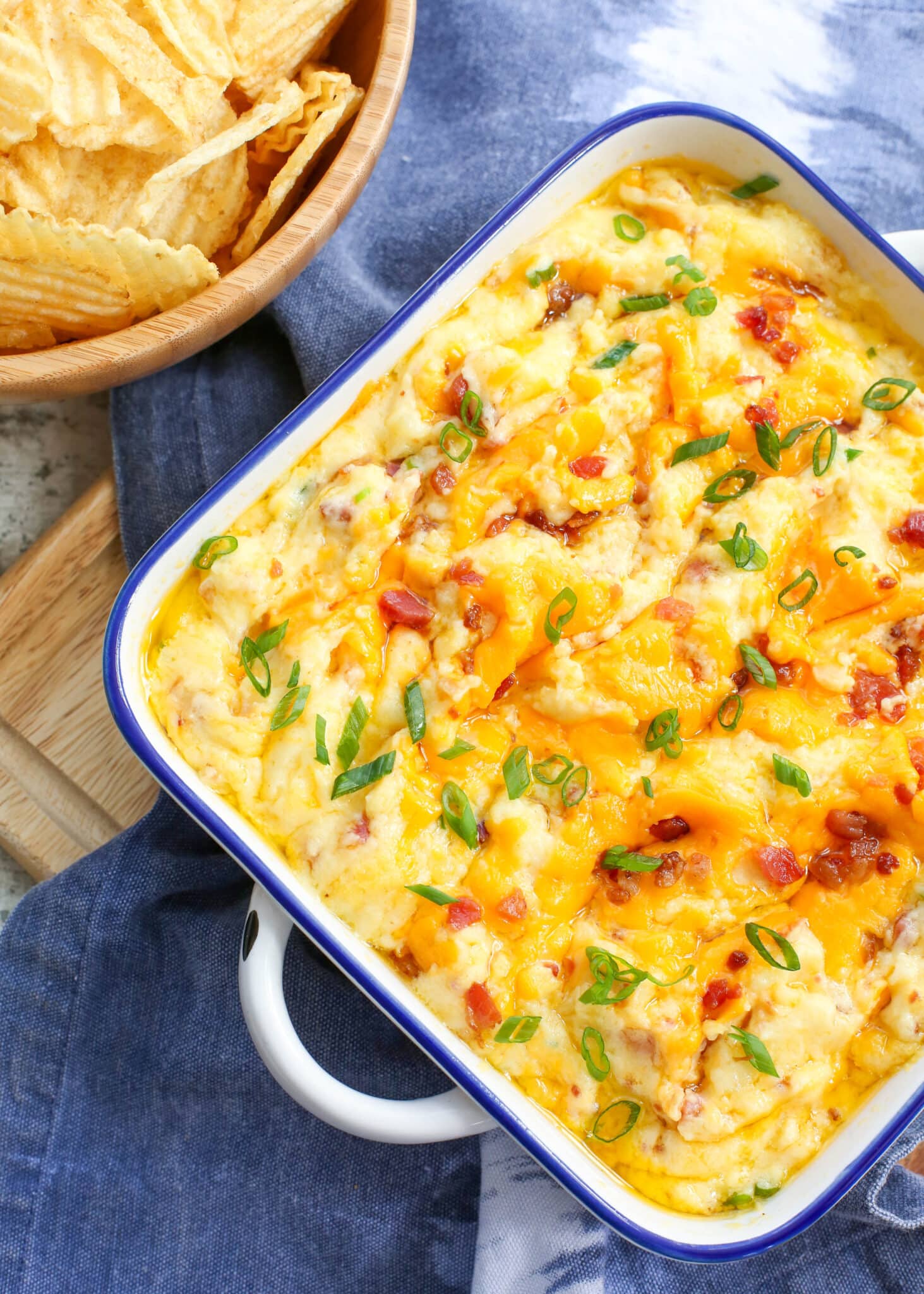 Everyone loves Twice Baked Potatoes and this dip maximizes that flavor combo in an EASY crowd friendly recipe! get the details at barefeetinthekitchen.com