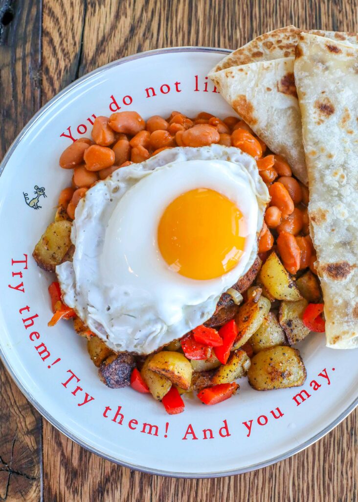 Huevos Rancheros with beans, potatoes, and green chile sauce