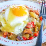 Huevos Rancheros with beans, potatoes, and plenty of green chile sauce