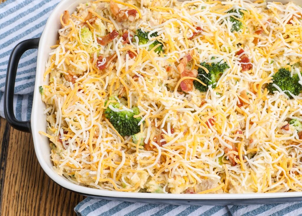 cheese topped casserole with potatoes, chicken, and broccoli