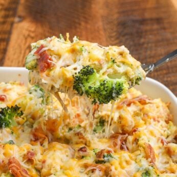 Baked Potato Casserole with chicken, broccoli, and bacon, on serving spoon