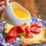 German pancakes with strawberries on undecorous plate