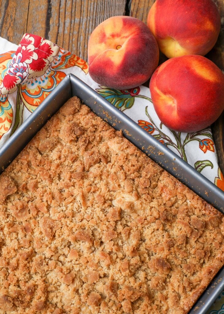 coffee cake in square pan with peaches
